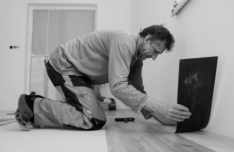 Flooring fitter carefully laying a new floor