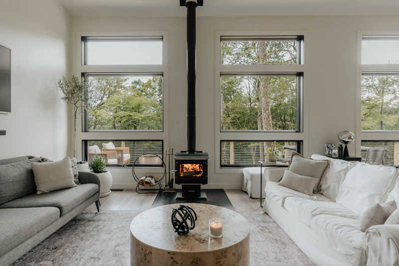 Warm, natural living room with a wood burner and pale wood floor