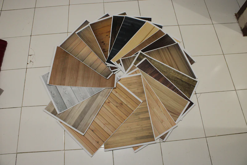 A fan of flooring samples in different wood tones