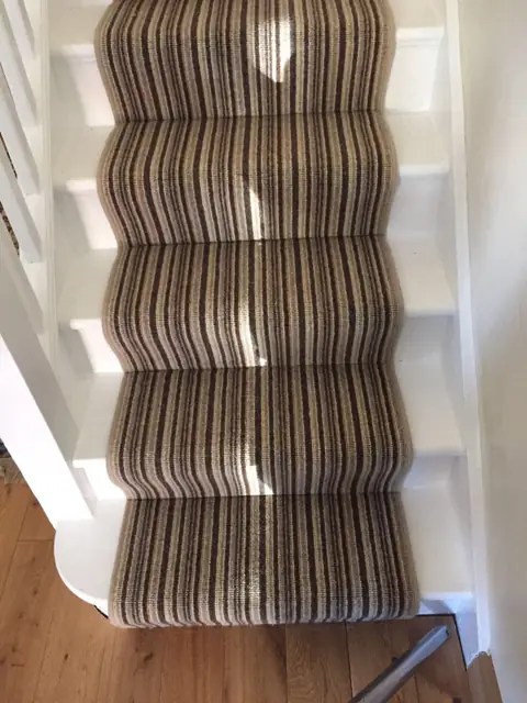 Striped stair carpet with oak hallway