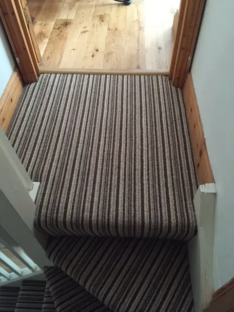 Landing and top step, striped carpet