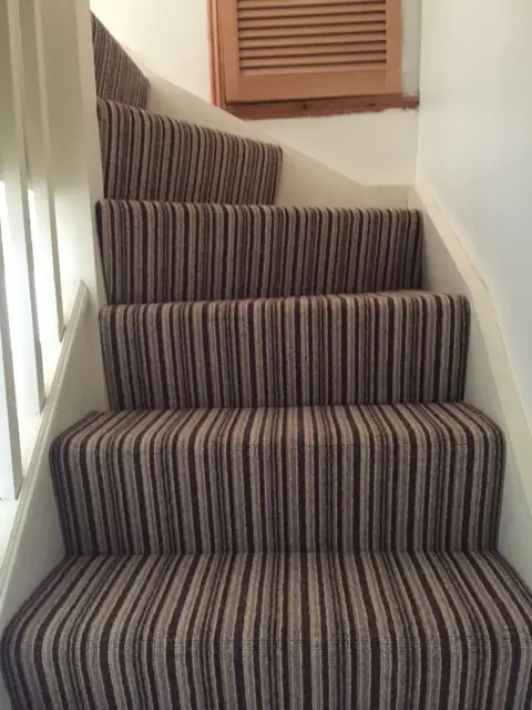 Striped carpet on a turning staircase